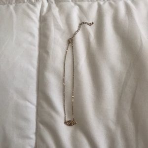 A gold eye necklace